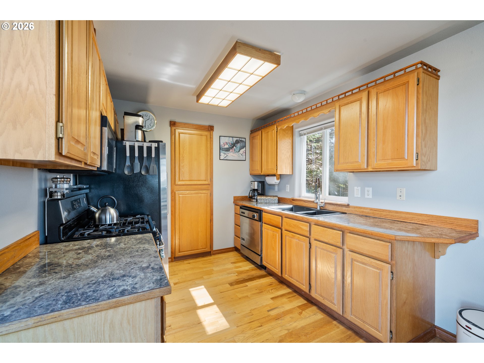6095 Huckleberry Lane Oceanside, OR 97141 - Photo 13 of 48 a kitchen with stainless steel appliances granite countertop sink window and refrigerator