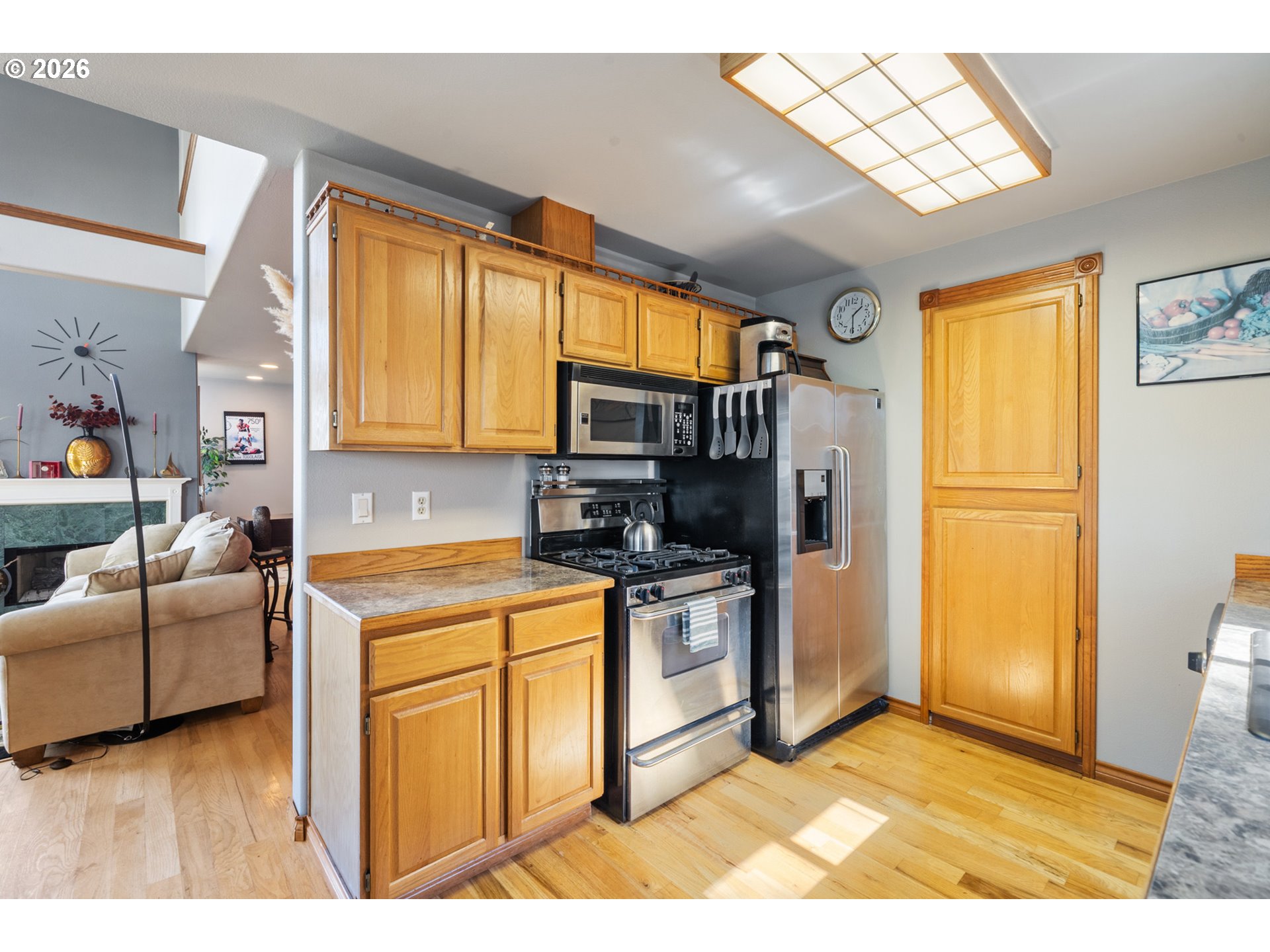 6095 Huckleberry Lane Oceanside, OR 97141 - Photo 14 of 48 a kitchen with stainless steel appliances granite countertop a refrigerator a stove a sink and a microwave