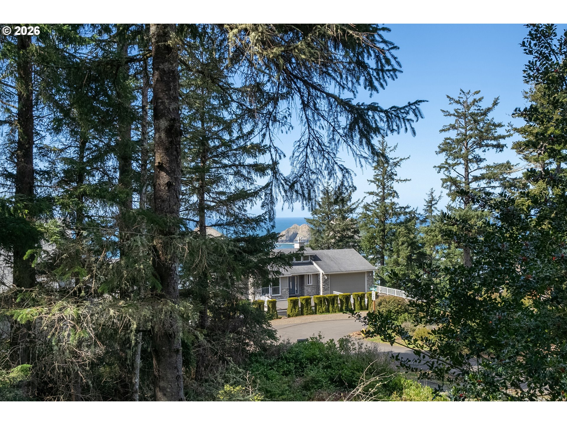 6095 Huckleberry Lane Oceanside, OR 97141 - Photo 2 of 48 a view of a house with a tree in front of it