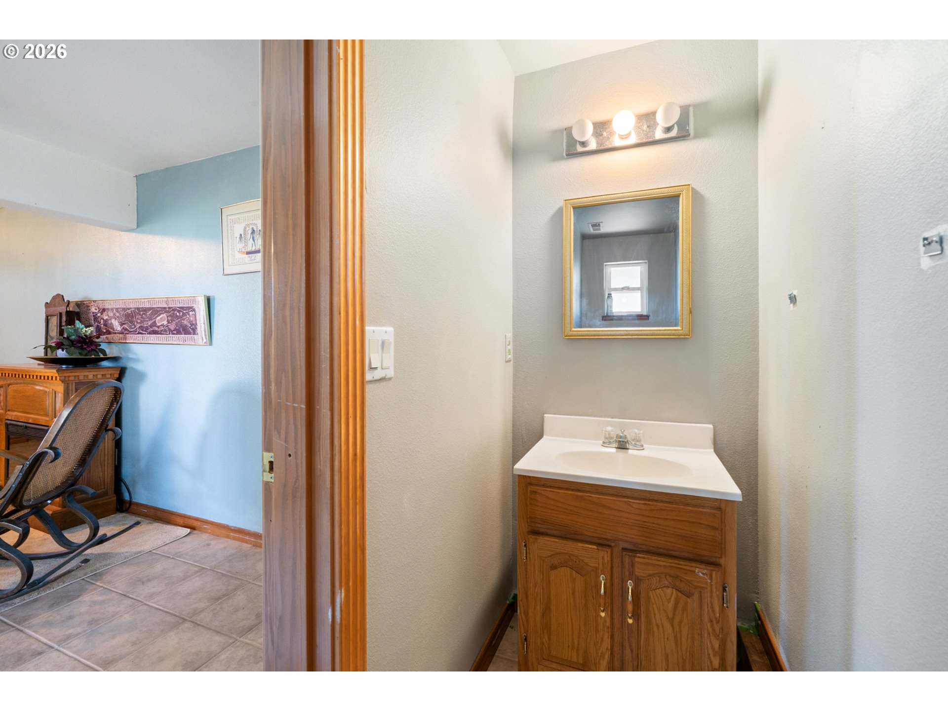 6095 Huckleberry Lane Oceanside, OR 97141 - Photo 34 of 48 a bathroom with a sink a mirror and cabinets