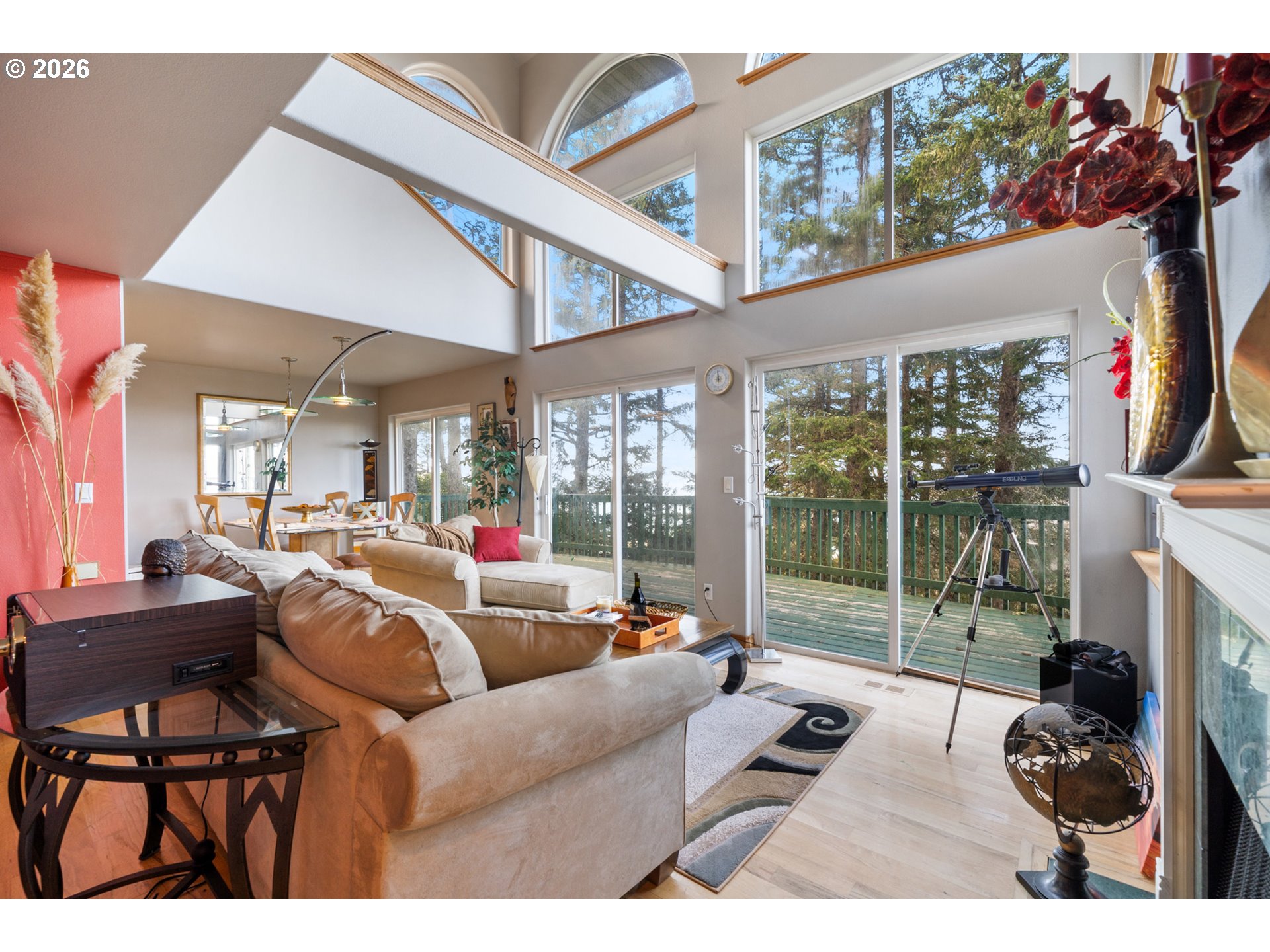 6095 Huckleberry Lane Oceanside, OR 97141 - Photo 4 of 48 a living room with fireplace furniture and a floor to ceiling window