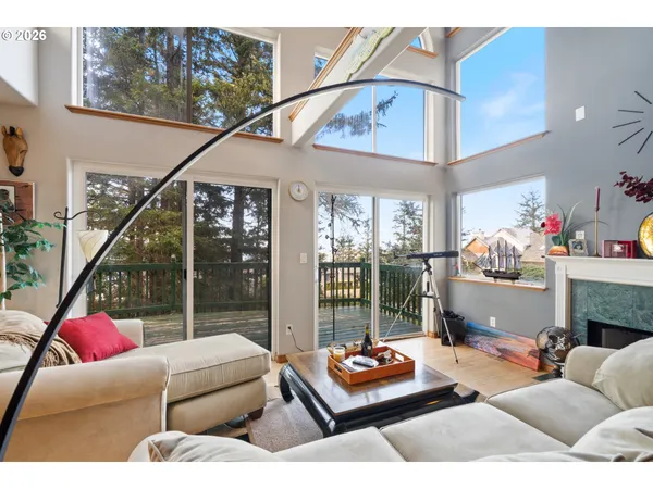 a living room with furniture and a floor to ceiling window