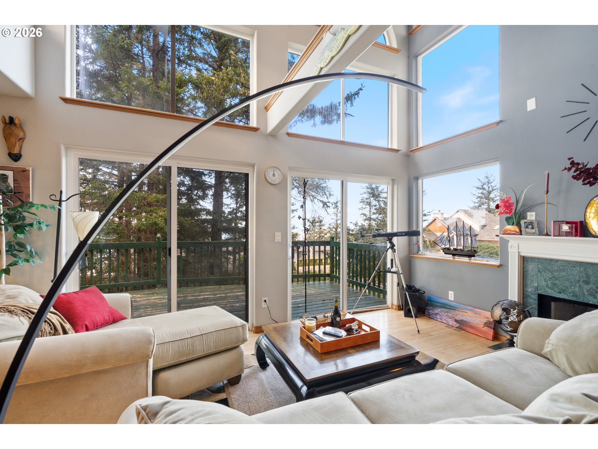 6095 Huckleberry Lane Oceanside, OR 97141 - Photo 5 of 48 a living room with furniture and a floor to ceiling window