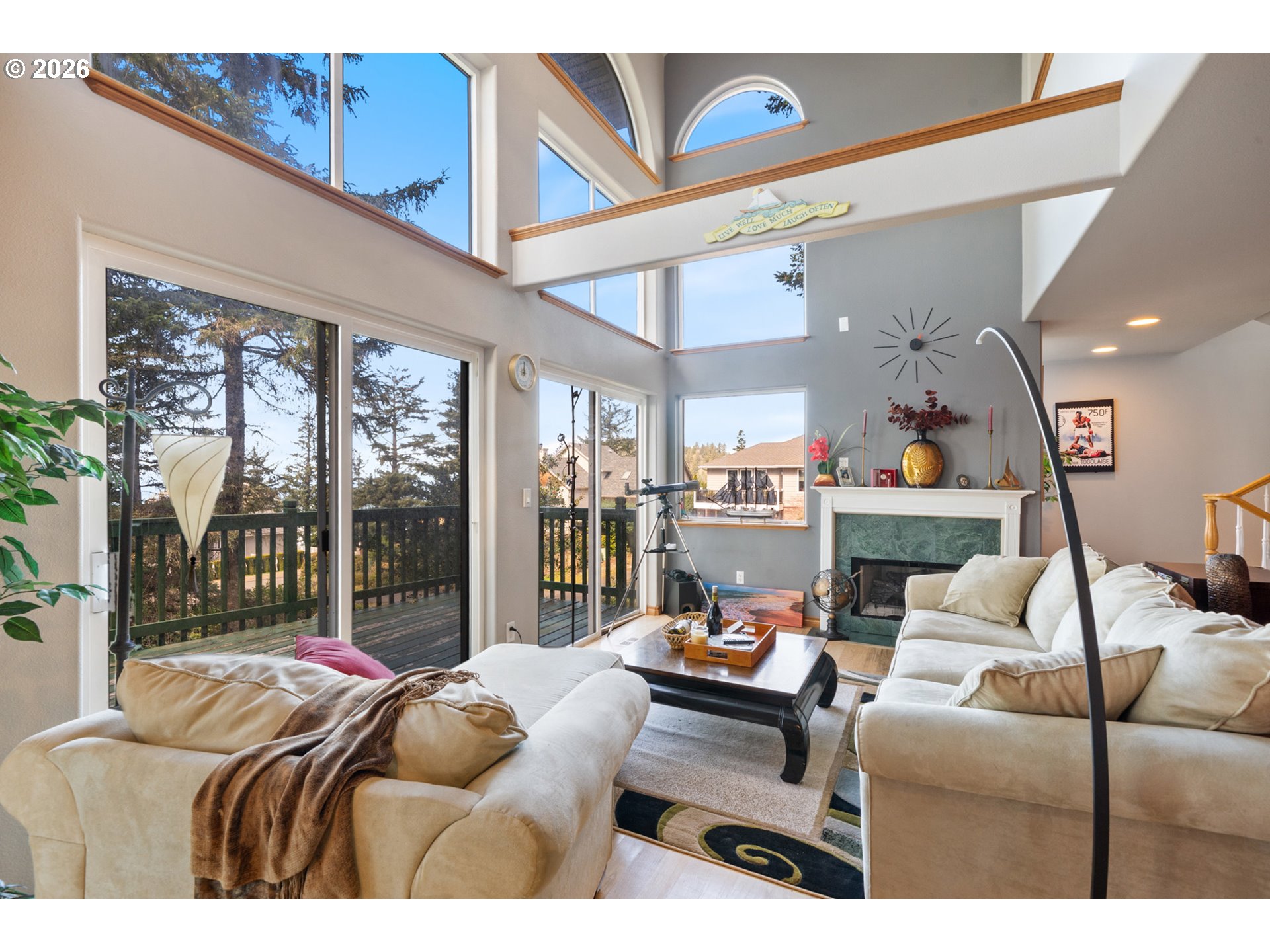 6095 Huckleberry Lane Oceanside, OR 97141 - Photo 6 of 48 a living room with furniture a large window and a chandelier