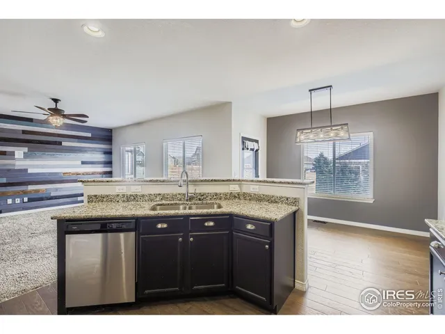 a room with granite countertop a sink and cabinets