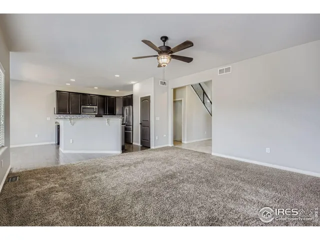a view of a kitchen with a sink and a ceiling fan