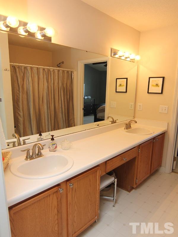 4822 Shallowbrook Trail Raleigh, NC 27616 - Photo 16 of 23 The master bath boasts dual vanities and a large tub/shower.