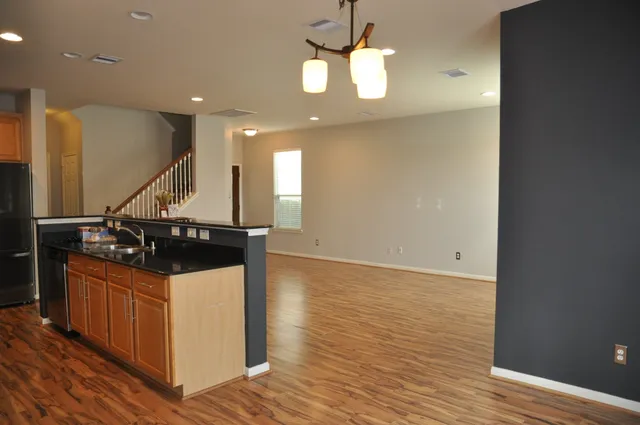 a kitchen with granite countertop a stove and a sink