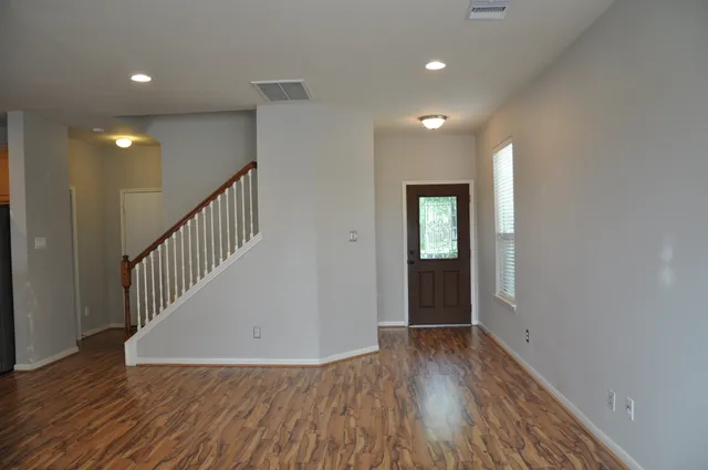 an entryway in a hall with an entryway and wooden floor