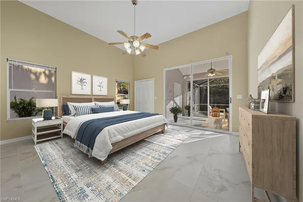 a bedroom with a large bed and a chandelier