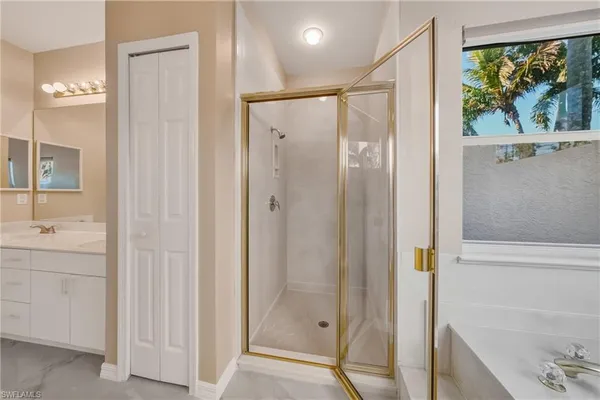 a bathroom with a shower and a sink