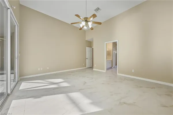 an empty room with windows and closet