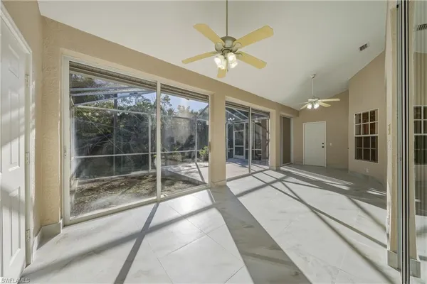 a view of a room with wooden floor and next to a window