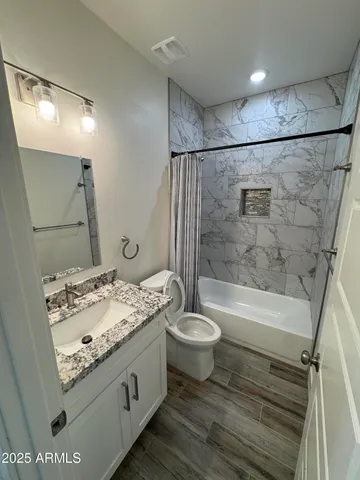 a bathroom with a sink a toilet and bathtub
