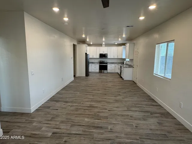 a view of kitchen with microwave and refrigerator