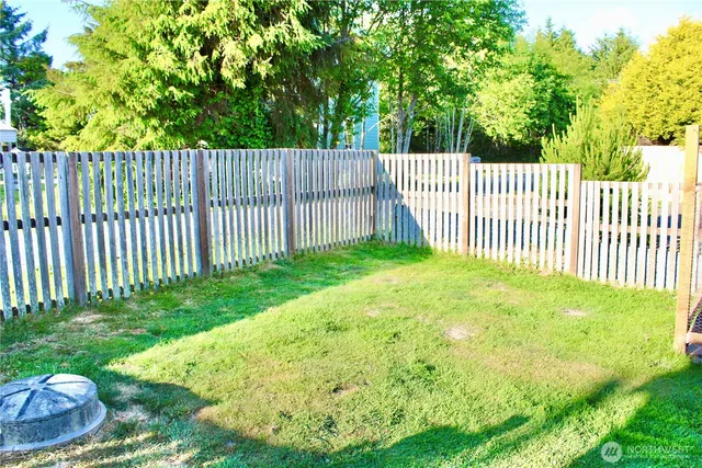 a view of a yard with a fence