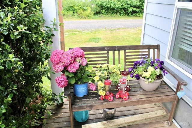 a front view of a house with a flower garden
