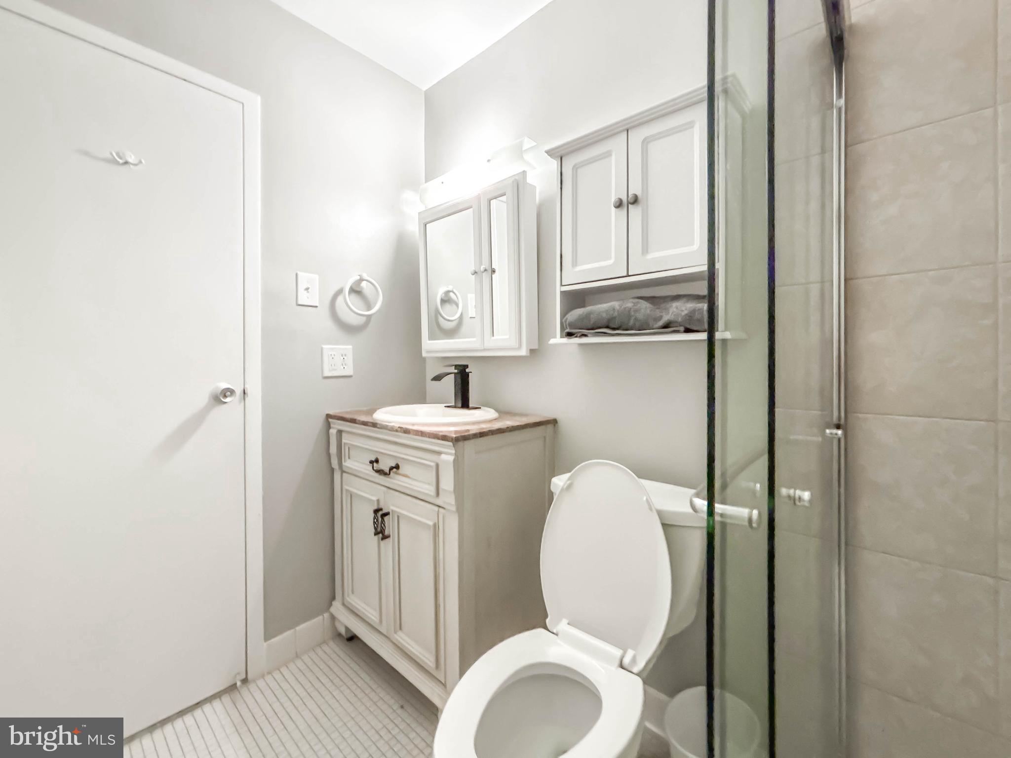 130 Slade Avenue, Unit 414 Baltimore, MD 21208 - Photo 32 of 48 a bathroom with a toilet sink and mirror