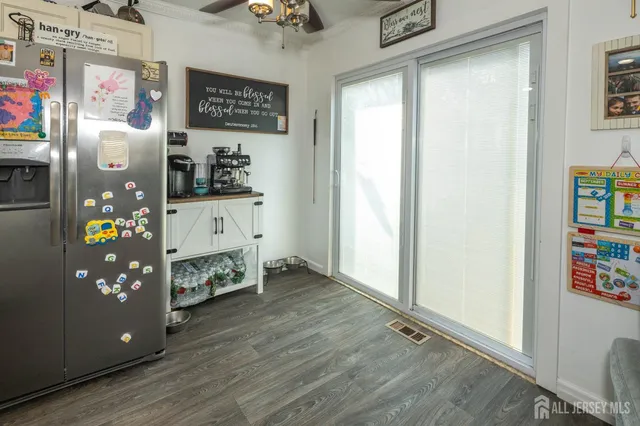 a view of a hallway with wooden floor and dining room