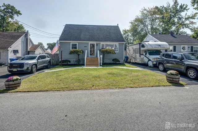 a view of a house with a patio and a yard