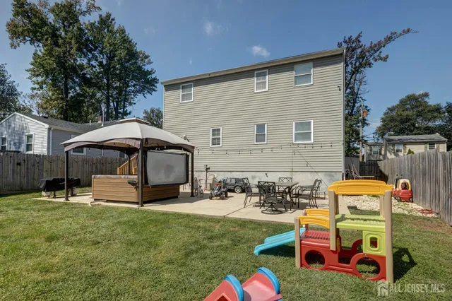 a front view of a house with garden and sitting area