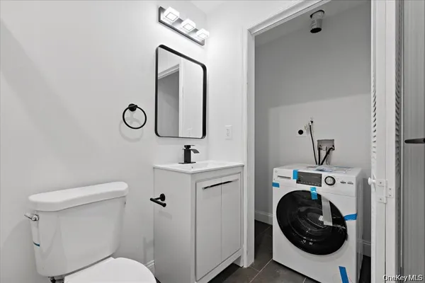 a bathroom with a toilet sink and mirror