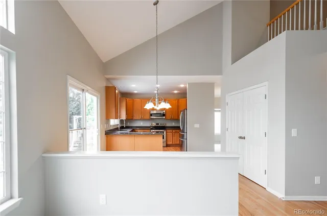 a kitchen with stainless steel appliances a large window and a refrigerator