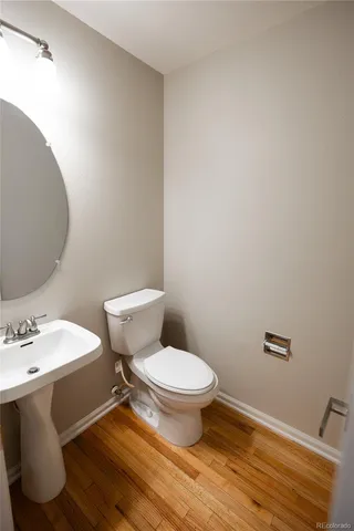 a white toilet sitting next to a bathroom sink