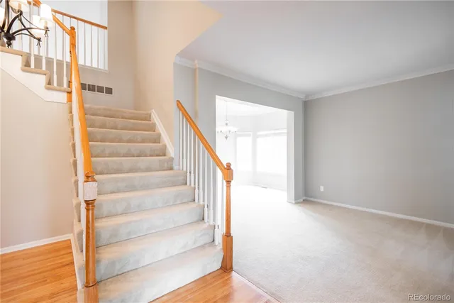 a view of staircase with white walls and a window