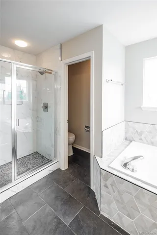 a bathroom with a tub shower and a sink