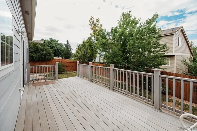 a view of backyard with deck and wooden floor