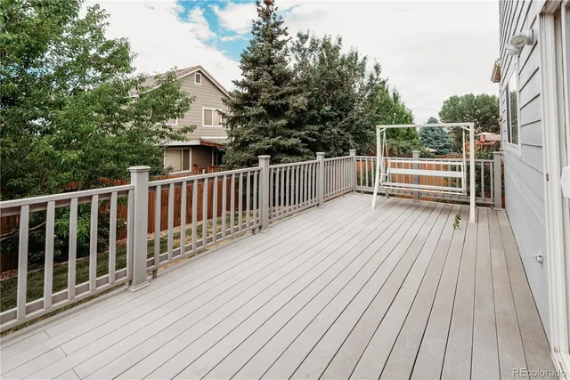 a view of backyard with deck and wooden floor
