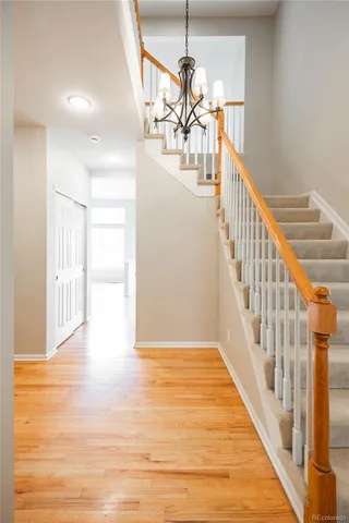 a view of entryway and hall with wooden floor