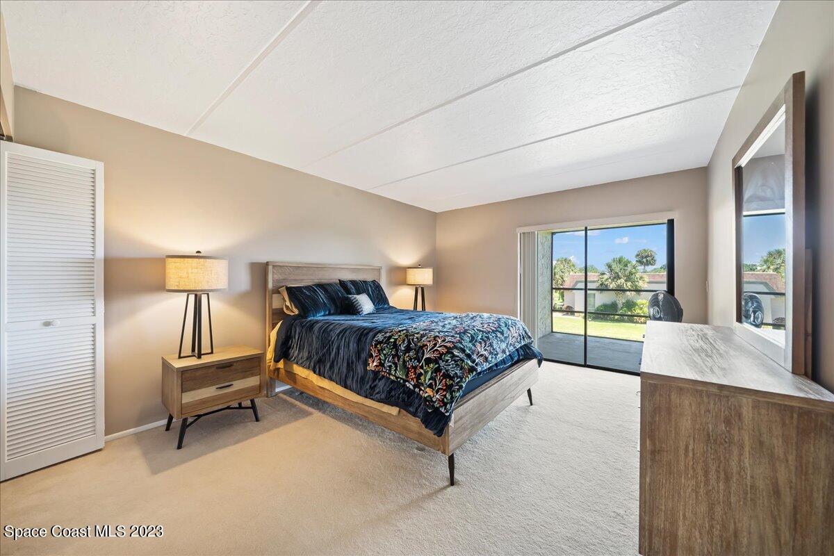 2775 North Wickham Road, Unit 204 Melbourne, FL 32935 - Photo 11 of 24 a bedroom with a large bed and a large window
