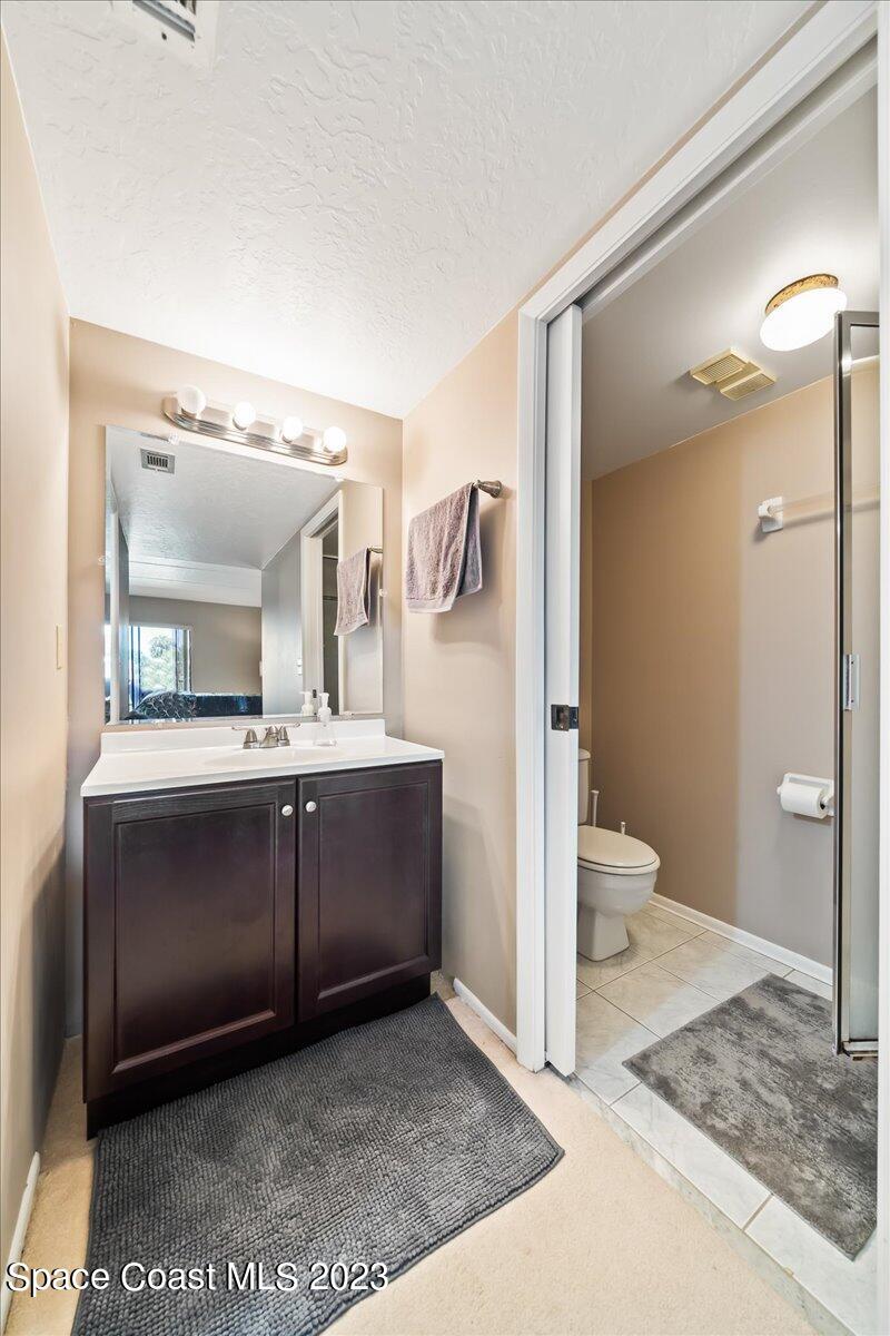 2775 North Wickham Road, Unit 204 Melbourne, FL 32935 - Photo 14 of 24 a bathroom with a sink and mirror