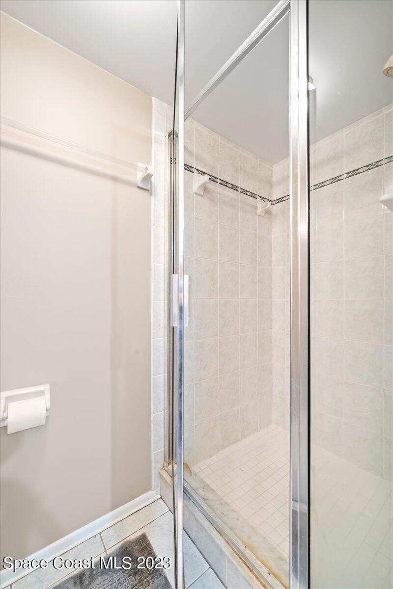 2775 North Wickham Road, Unit 204 Melbourne, FL 32935 - Photo 16 of 24 a bathroom with a glass shower door