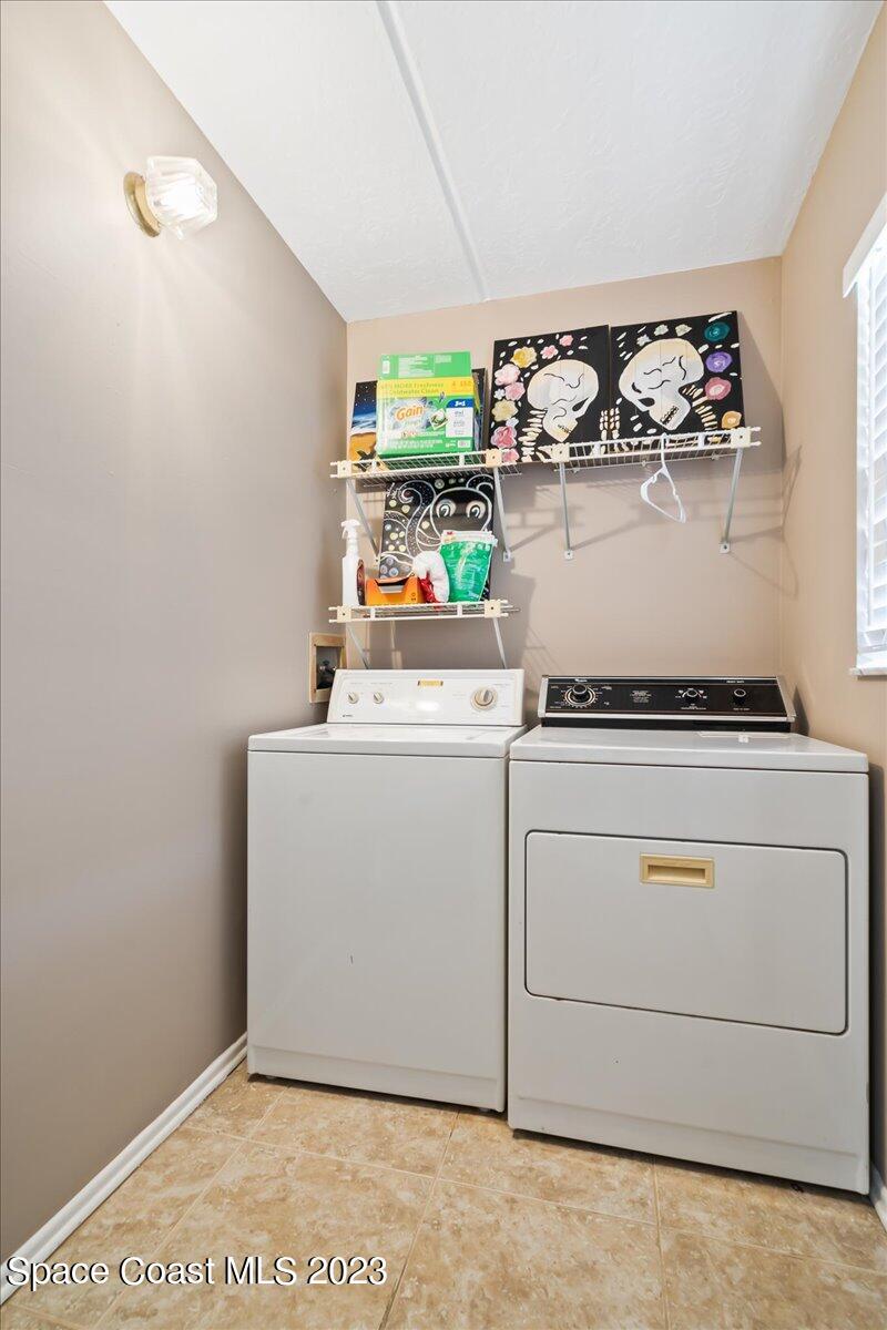 2775 North Wickham Road, Unit 204 Melbourne, FL 32935 - Photo 19 of 24 a utility room with dryer and washer