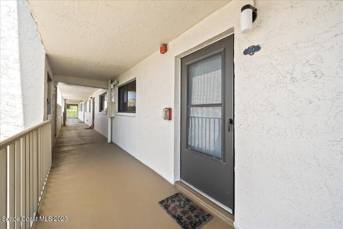 2775 North Wickham Road, Unit 204 Melbourne, FL 32935 - Photo 2 of 24 a view of hallway with livingroom