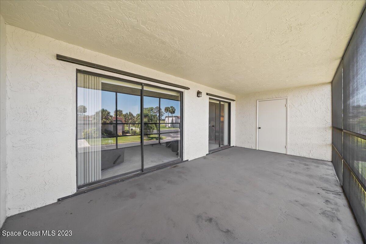 2775 North Wickham Road, Unit 204 Melbourne, FL 32935 - Photo 21 of 24 a view of an empty room with a sliding door