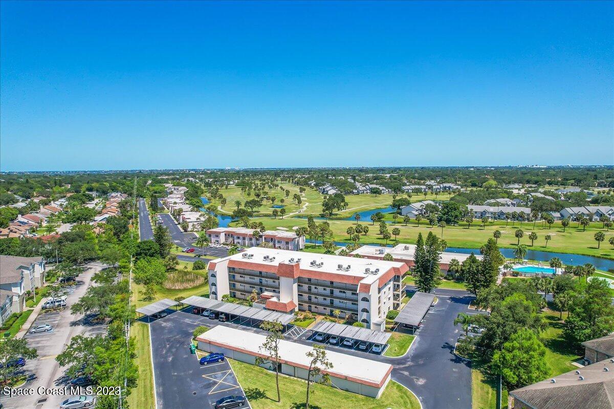 2775 North Wickham Road, Unit 204 Melbourne, FL 32935 - Photo 24 of 24 an aerial view of a city with lawn chairs
