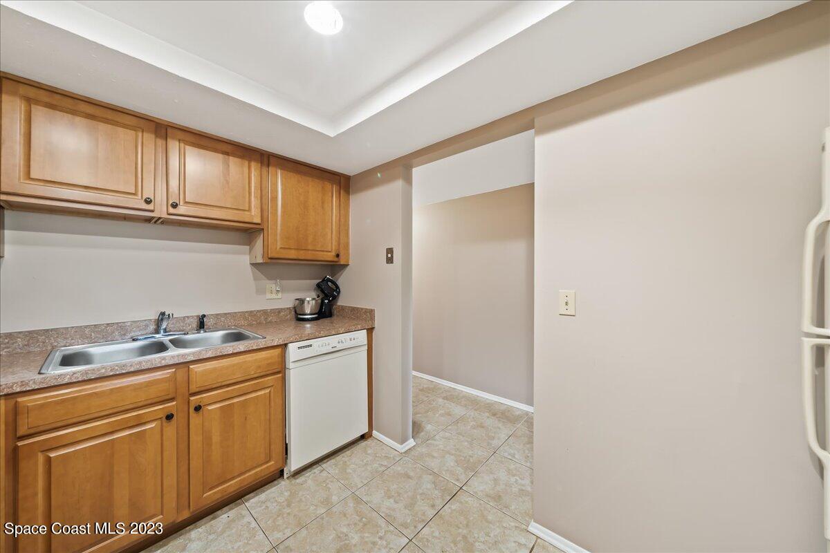 2775 North Wickham Road, Unit 204 Melbourne, FL 32935 - Photo 5 of 24 a kitchen with a sink cabinets and utility