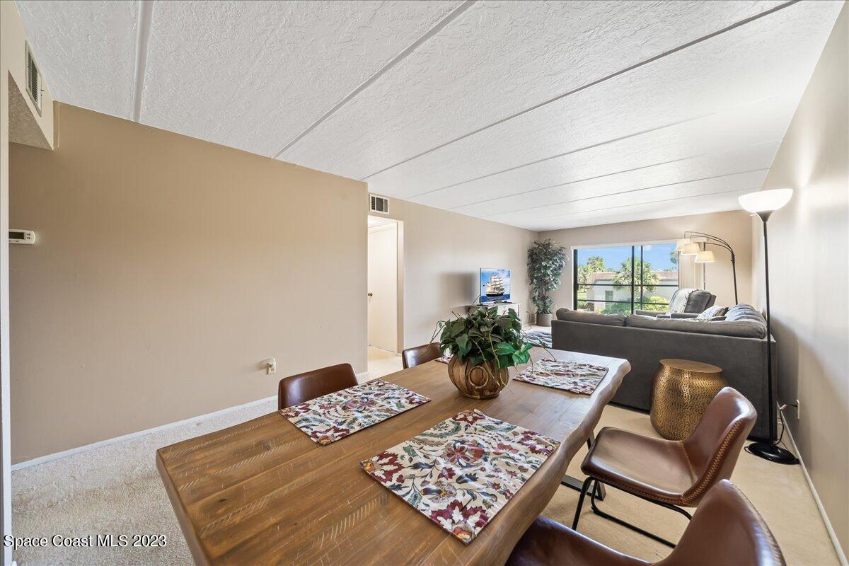 2775 North Wickham Road, Unit 204 Melbourne, FL 32935 - Photo 8 of 24 a bedroom with a bed table flowerpot and window