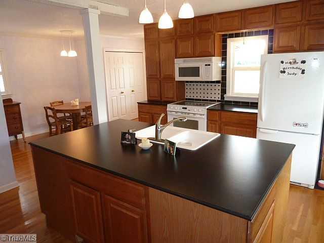 Kitchen. Totally remodeled kitchen with hardwood floors and island..
