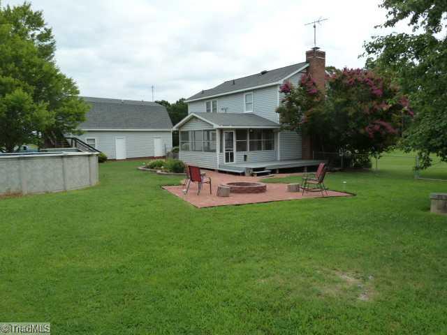 7741 Ferrin Road Browns Summit, NC 27214 - Photo 10 of 12 Exterior Back. Pool!! Fire pit! Bricked Patio!! PERFECT FOR ENTERTAINING!!