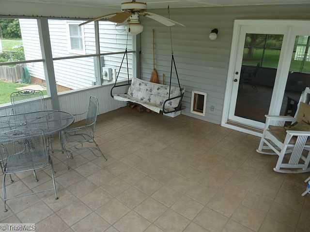 7741 Ferrin Road Browns Summit, NC 27214 - Photo 9 of 12 Enclosed Porch. Screened porch with ceramic tile floor... make this yours today!!