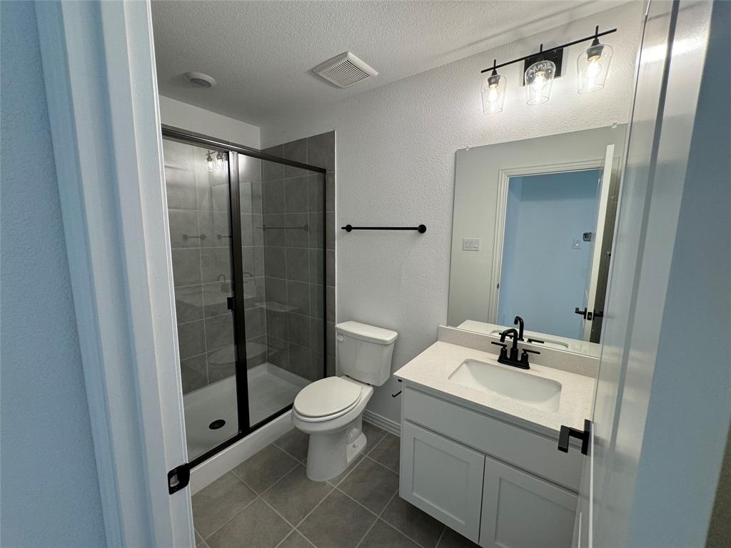 4708 Craymore Road Dallas, TX 75228 - Photo 15 of 16 a bathroom with a sink toilet and shower
