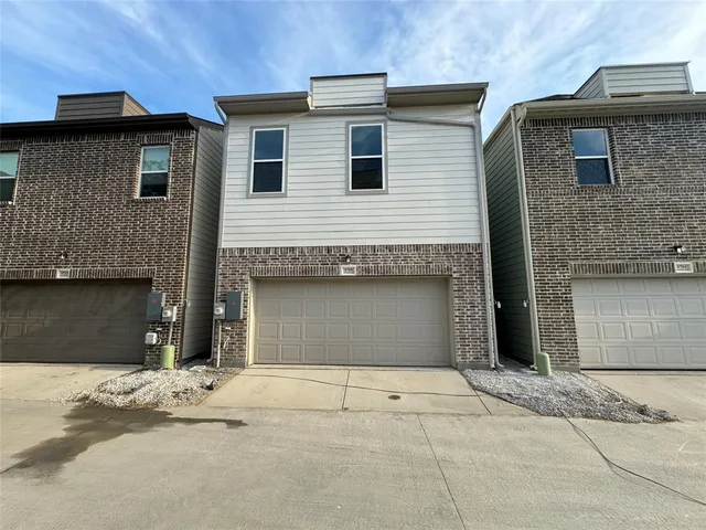 a front view of a house with a garage