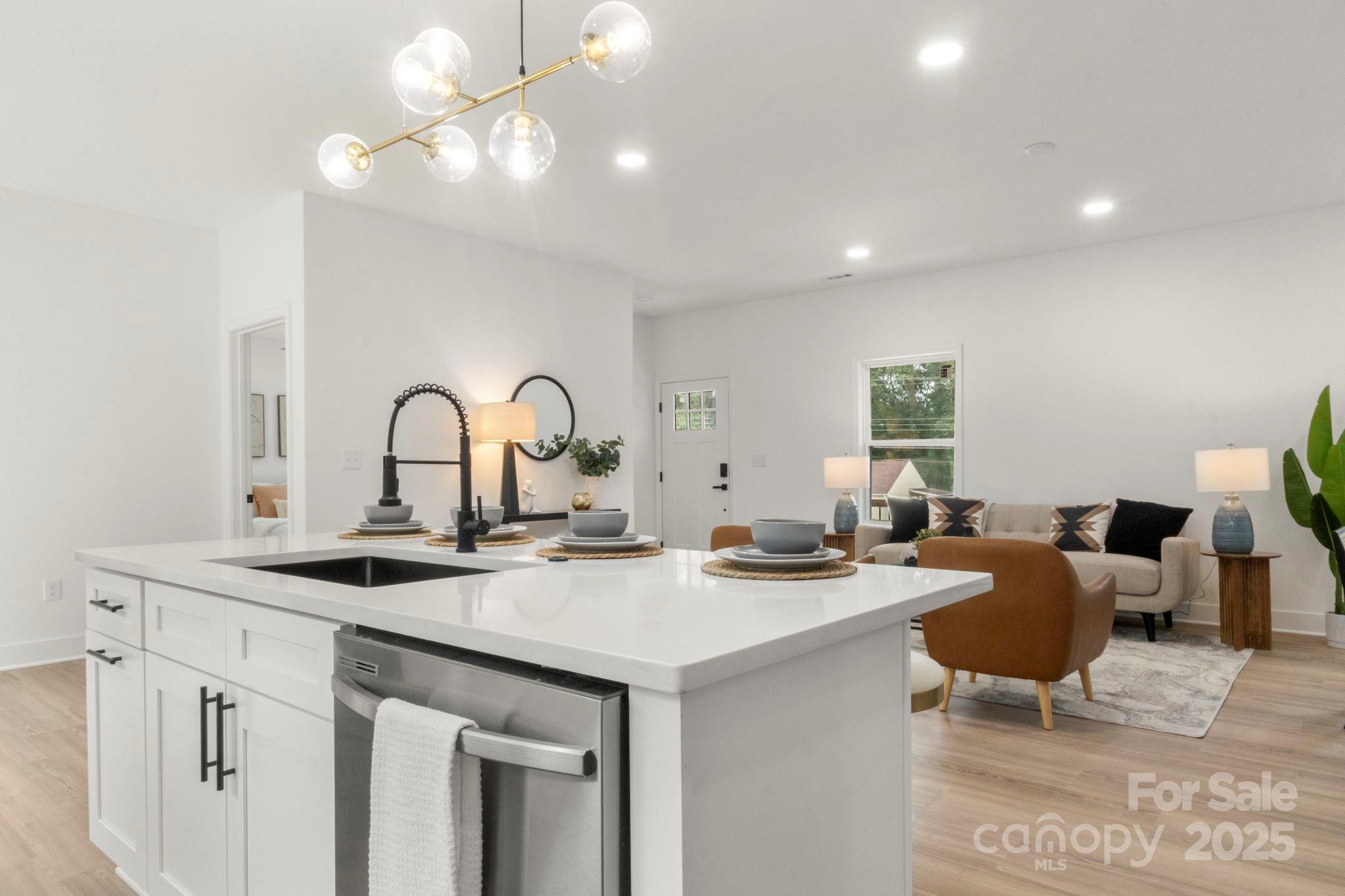 614 Hardin Road Dallas, NC 28034 - Photo 12 of 37 a kitchen with a sink a table and chairs