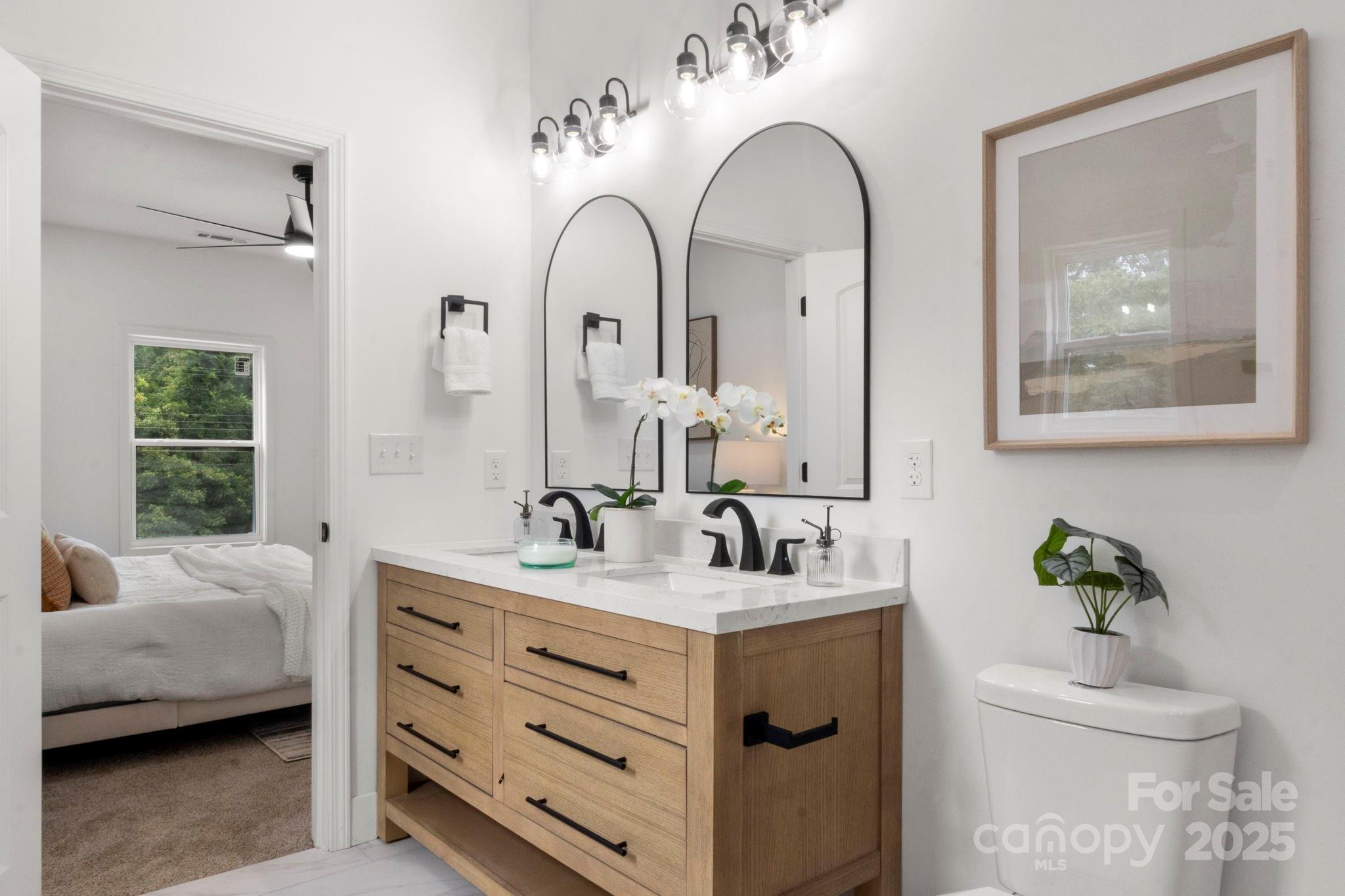 614 Hardin Road Dallas, NC 28034 - Photo 20 of 37 a en suite bathroom with double vanity a toilet a and a window