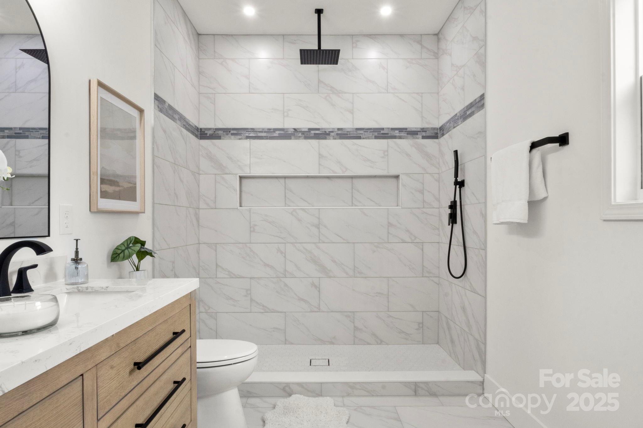 614 Hardin Road Dallas, NC 28034 - Photo 21 of 37 a bathroom with a granite countertop sink a toilet and shower